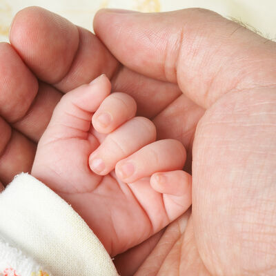 Baby hand in father's palm